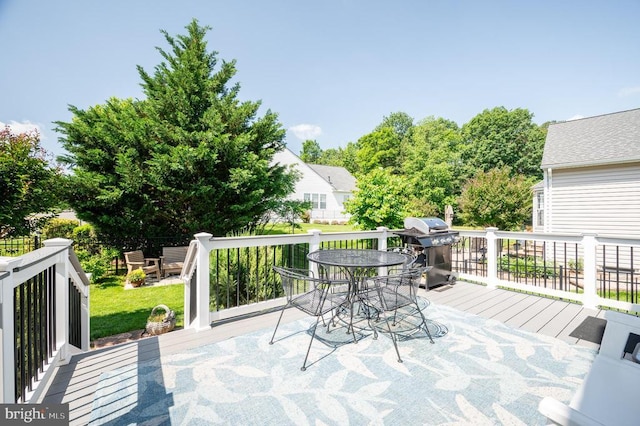  - deck featuring outdoor dining area and area for grilling