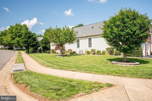  - view of property exterior featuring central AC unit and a lawn