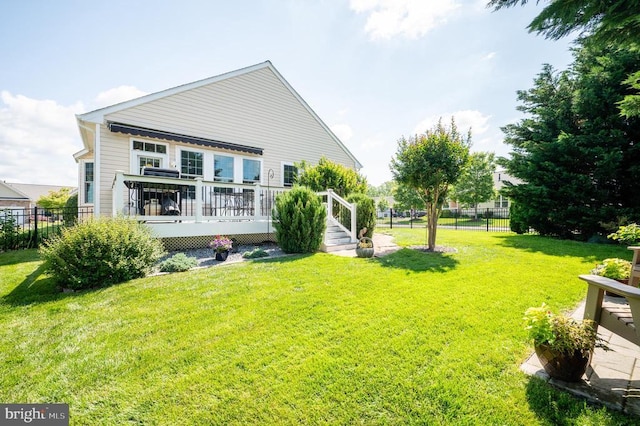  - back of house featuring a wooden deck
