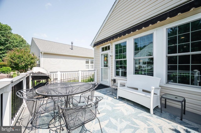  - wooden deck with outdoor dining area