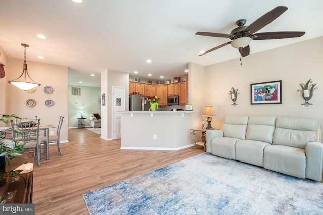  - living room featuring recessed lighting, a ceiling fan, light wood finished floors, and baseboards