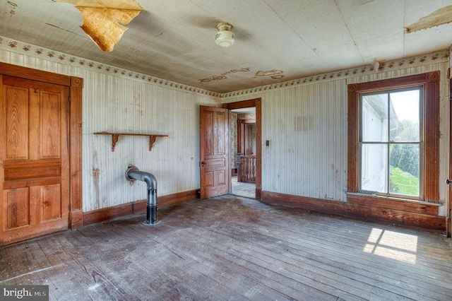 unfurnished room with hardwood / wood-style floors, baseboards, and plenty of natural light