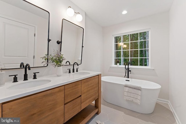 13191 Scotts Ml, Culpeper, VA 22701 - bathroom featuring double vanity, a freestanding tub, tile patterned floors, baseboards, and recessed lighting