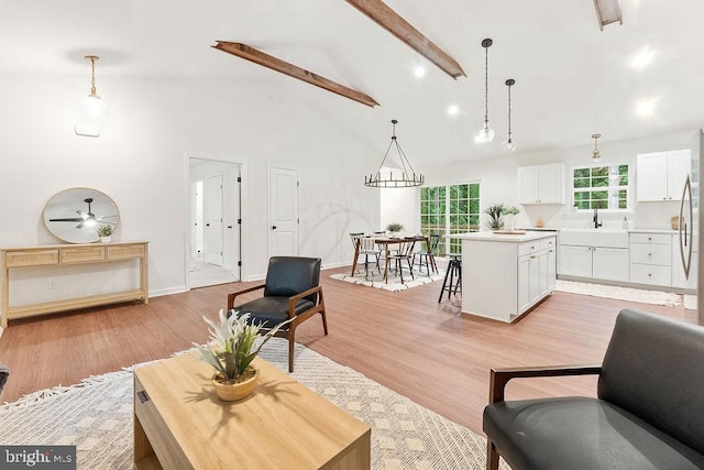 13191 Scotts Ml, Culpeper, VA 22701 - living room featuring beam ceiling, light wood finished floors, baseboards, high vaulted ceiling, and a chandelier