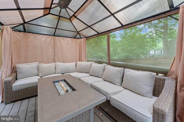 10603 Eden Brook Dr, Spotsylvania, VA 22553 - sunroom / solarium featuring an outdoor living space with a fire pit, vaulted ceiling, and healthy amount of natural light