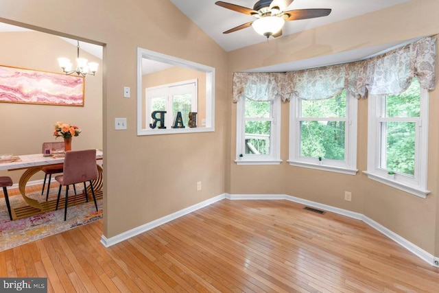 10603 Eden Brook Dr, Spotsylvania, VA 22553 - unfurnished dining area featuring light wood-style floors, lofted ceiling, a ceiling fan, a chandelier, and baseboards