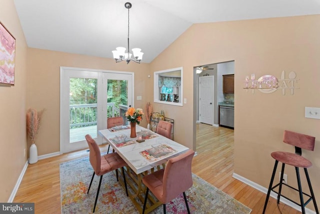 10603 Eden Brook Dr, Spotsylvania, VA 22553 - dining area with light wood-style floors, vaulted ceiling, a chandelier, and baseboards