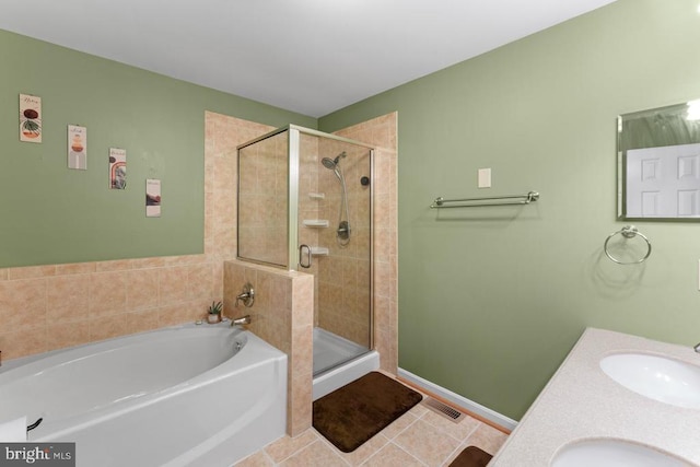 10603 Eden Brook Dr, Spotsylvania, VA 22553 - bathroom featuring a garden tub, a stall shower, tile patterned floors, baseboards, and double vanity