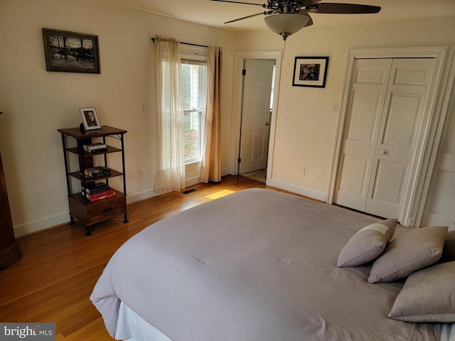  - bedroom featuring wood finished floors, baseboards, and ceiling fan
