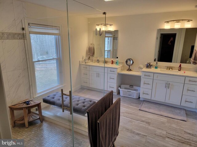  - bathroom featuring two vanities and healthy amount of natural light