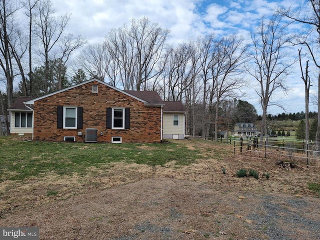  - back of house with central AC unit and brick siding