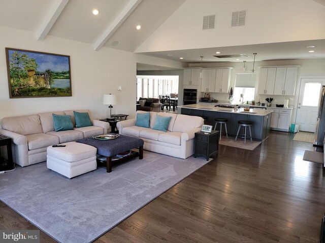  - living room featuring dark wood-type flooring, high vaulted ceiling, beamed ceiling, and recessed lighting