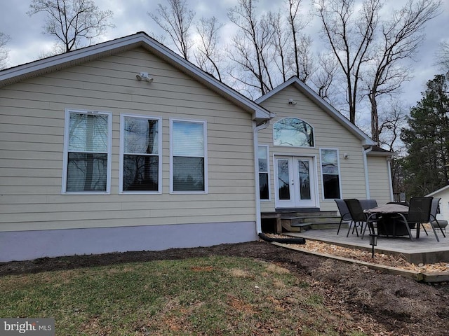  - back of property featuring french doors, a patio, and a yard