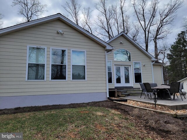  - rear view of house featuring french doors, a patio area, and a yard