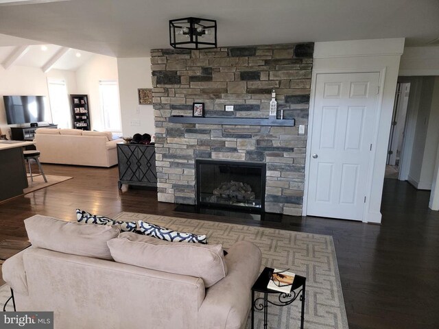  - living area with wood finished floors, a stone fireplace, and recessed lighting