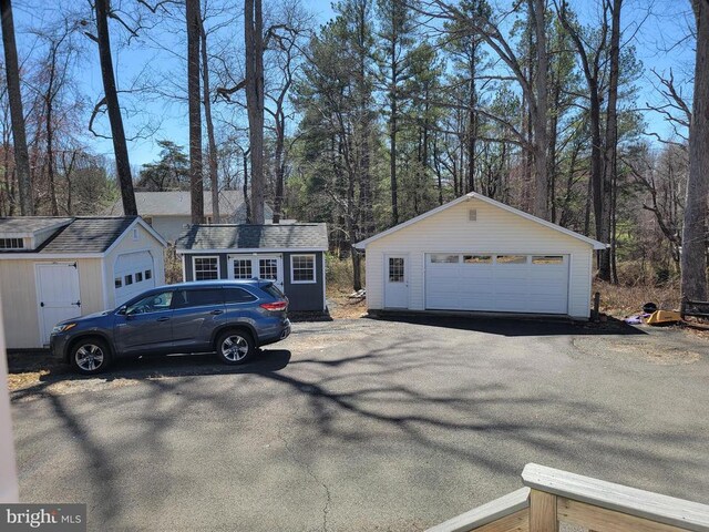  - view of front of home featuring an outbuilding and a detached garage