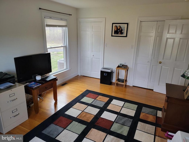  - office space with light wood finished floors
