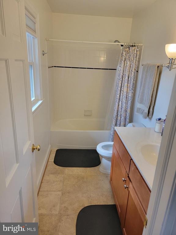  - bathroom with tile patterned flooring, shower / bath combo with shower curtain, toilet, and vanity