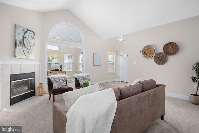 6231 Autumn Leaf Dr, Fredericksburg, VA 22407 - living area with light colored carpet, healthy amount of natural light, a tile fireplace, high vaulted ceiling, and baseboards