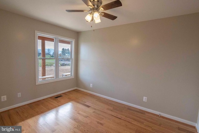 spare room featuring light hardwood / wood-style floors and ceiling fan