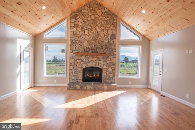 unfurnished living room featuring wood ceiling, plenty of natural light, and high vaulted ceiling