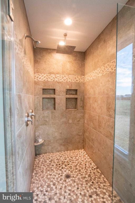 bathroom with tiled shower