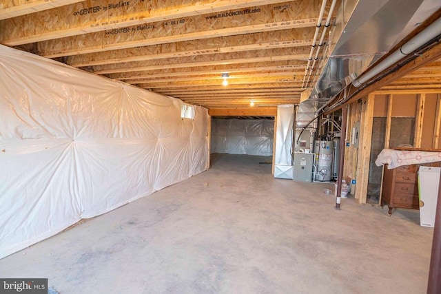 basement featuring heating unit and water heater