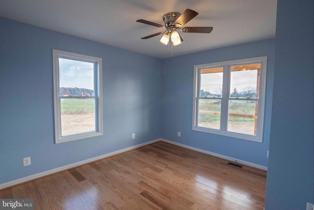 spare room featuring light hardwood / wood-style floors and ceiling fan