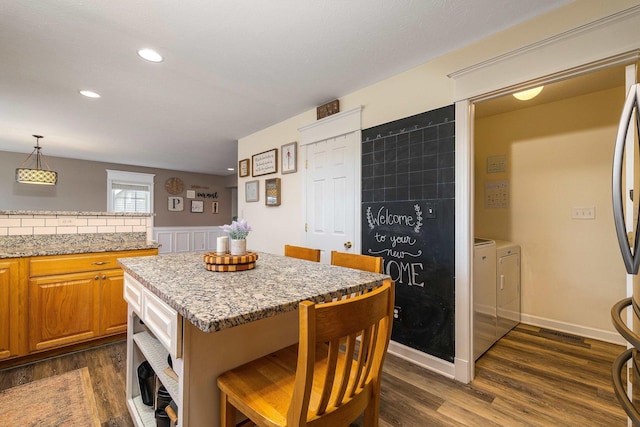 118 Wexford St, Staunton, VA 24401 - kitchen featuring washing machine and dryer, dark wood-style floors, light stone countertops, recessed lighting, and hanging light fixtures