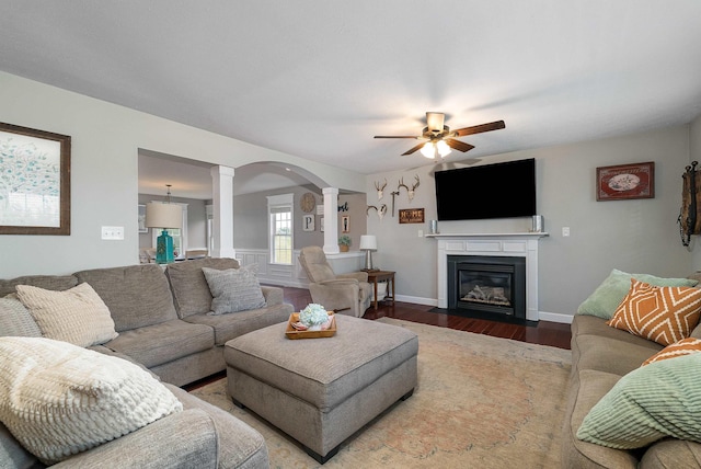 118 Wexford St, Staunton, VA 24401 - living room with ornate columns, a ceiling fan, wood finished floors, a fireplace with flush hearth, and arched walkways