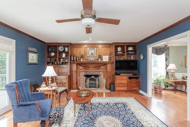 225 Divot Dr, Harrisonburg, VA 22802 - living area featuring light wood-style floors, ceiling fan, healthy amount of natural light, crown molding, and a brick fireplace