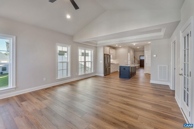 196 Thicket Run Pl, Charlottesville, VA 22911 - unfurnished living room with lofted ceiling, visible vents, ceiling fan, baseboards, and light wood-style floors