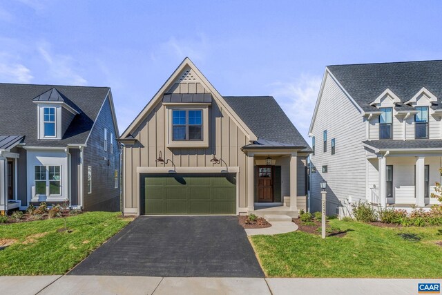 196 Thicket Run Pl, Charlottesville, VA 22911 - view of front facade with a front lawn, board and batten siding, a garage, and aphalt driveway