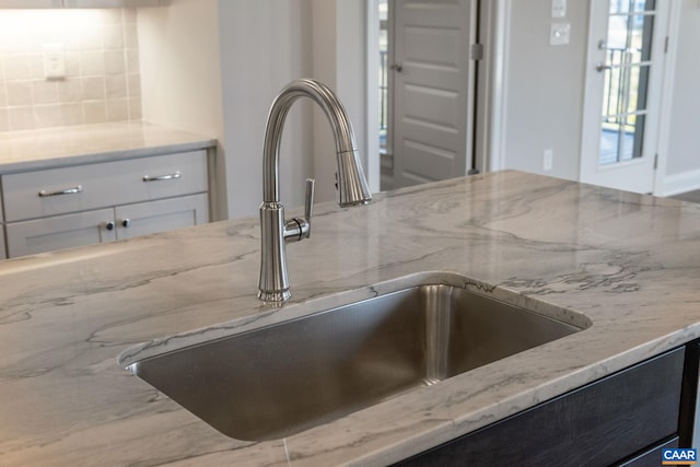 196 Thicket Run Pl, Charlottesville, VA 22911 - interior details featuring white cabinetry, light stone counters, tasteful backsplash, and a sink