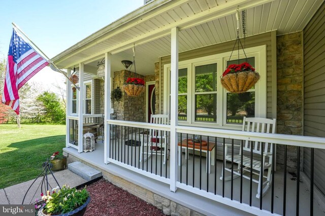 7329 Cloverhill Rd, Spotsylvania, VA 22551 - view of side of property featuring stone siding, covered porch, and a lawn