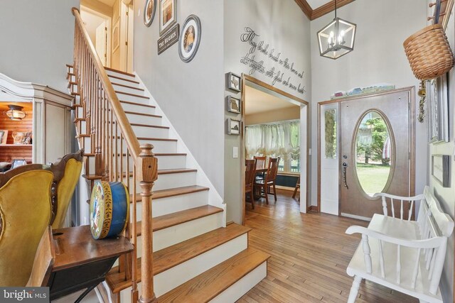 7329 Cloverhill Rd, Spotsylvania, VA 22551 - entryway featuring stairway, a chandelier, a high ceiling, wood finished floors, and baseboards