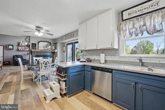 7329 Cloverhill Rd, Spotsylvania, VA 22551 - kitchen with stainless steel dishwasher, a sink, white cabinets, blue cabinetry, and a ceiling fan