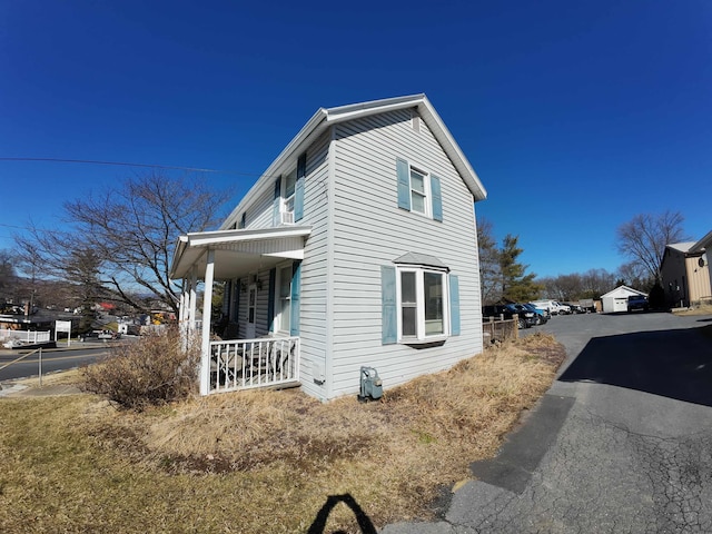 view of side of property with covered porch