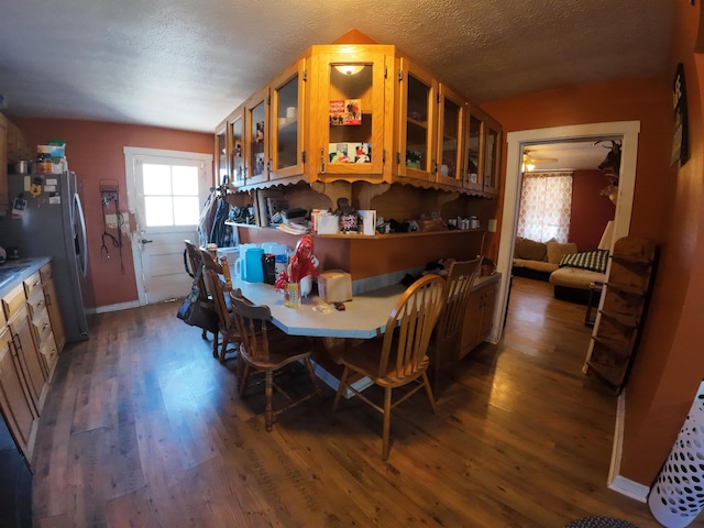 dining room featuring a textured ceiling and wood finished floors