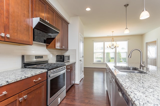 3267 Battery Park Pl, Rockingham, VA 22801 - kitchen featuring stainless steel appliances, range hood, dark wood-style floors, light stone counters, and a chandelier
