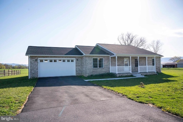 single story home with a porch, driveway, a garage, and brick siding