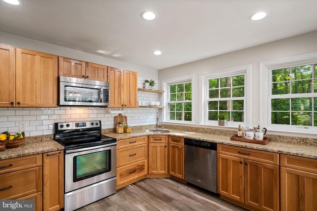 12800 Pickett Ct, Spotsylvania, VA 22551 - kitchen with stainless steel appliances, healthy amount of natural light, light wood-type flooring, tasteful backsplash, and recessed lighting
