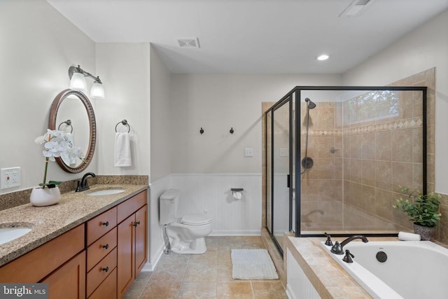 12800 Pickett Ct, Spotsylvania, VA 22551 - full bathroom featuring a garden tub, a shower stall, double vanity, tile patterned floors, and a wainscoted wall