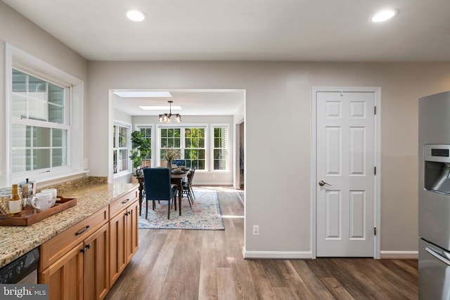 12800 Pickett Ct, Spotsylvania, VA 22551 - kitchen featuring stainless steel appliances, a chandelier, wood finished floors, light stone countertops, and recessed lighting