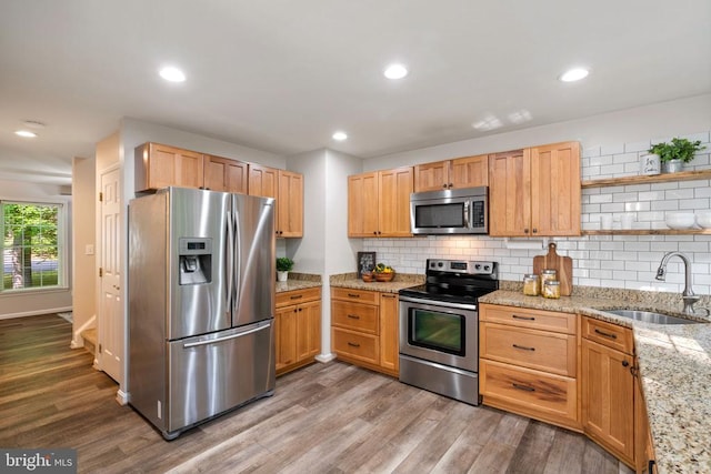 12800 Pickett Ct, Spotsylvania, VA 22551 - kitchen featuring stainless steel appliances, open shelves, wood finished floors, decorative backsplash, and light stone countertops