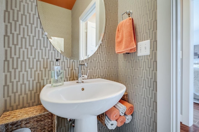 3436 Charleston Blvd, Rockingham, VA 22801 - bathroom with wallpapered walls, wood finished floors, and a sink