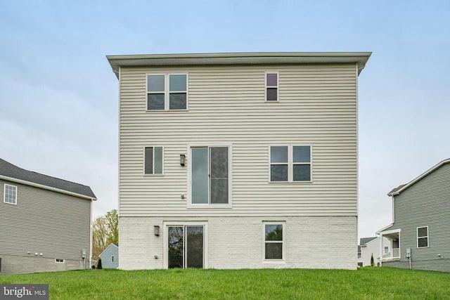 rear view of house with a yard