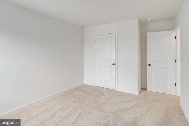 unfurnished bedroom featuring baseboards and carpet floors