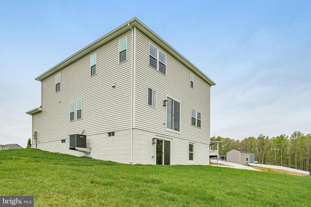 back of property featuring a yard