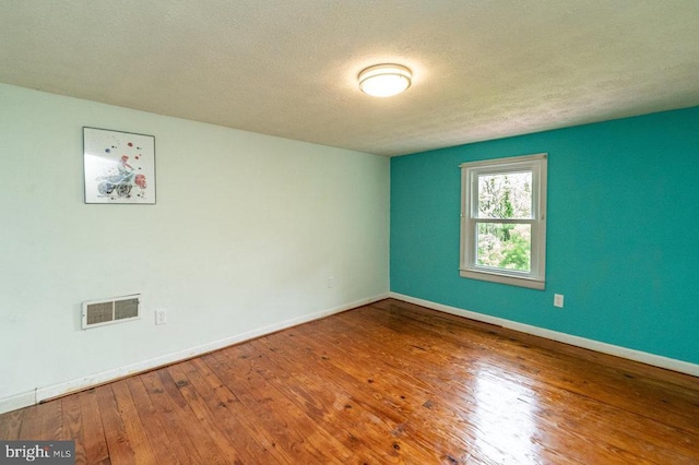 228 Black Bear Ln, Stanley, VA 22851 - empty room featuring hardwood / wood-style flooring, baseboards, and a textured ceiling